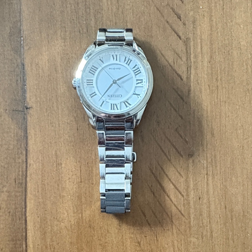 Citizen Eco-Drive White dial, Roman Numerals, stainless steel bracelet.